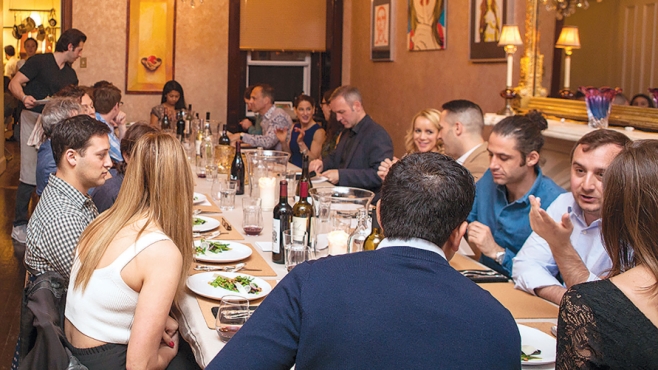 Diners gather around the table at Boku