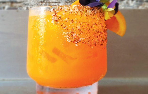 Cheers! A carrot-orange-mezcal cocktail from Vicio Mezcal: Drink Photo Courtesy Of Dock Street Brewing